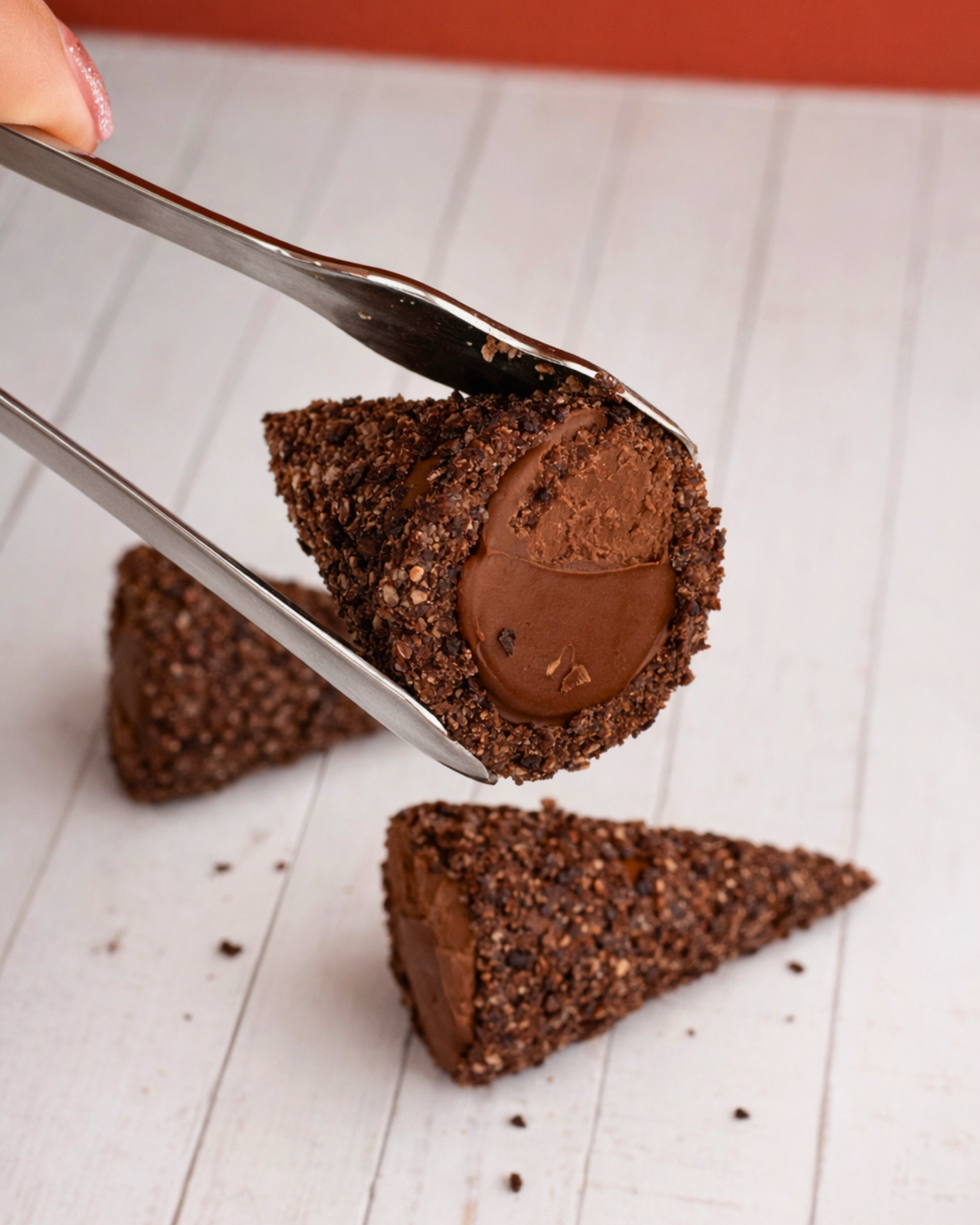 Medri Trottole Chocolate, a close-up of round chocolate balls with a glossy finish and intricate swirls on top.