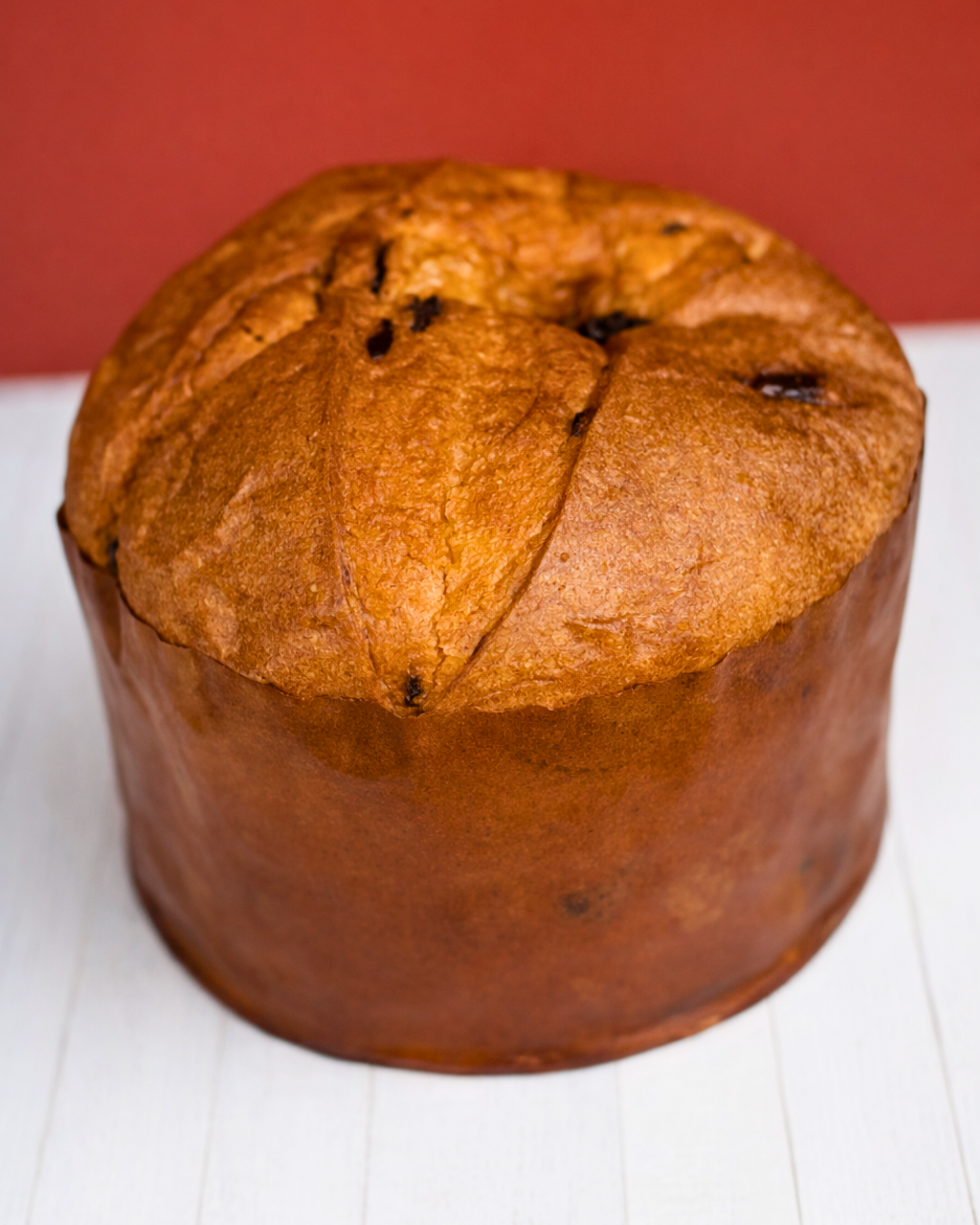 Medri Panettone Classico Negrini with golden-brown top, sliced to show soft, airy interior filled with dried fruits and raisins.