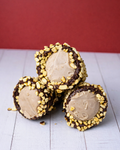 Medri Trottole Pistacho, colorful pistachio-flavored confections with vibrant swirls and intricate designs on a white background.