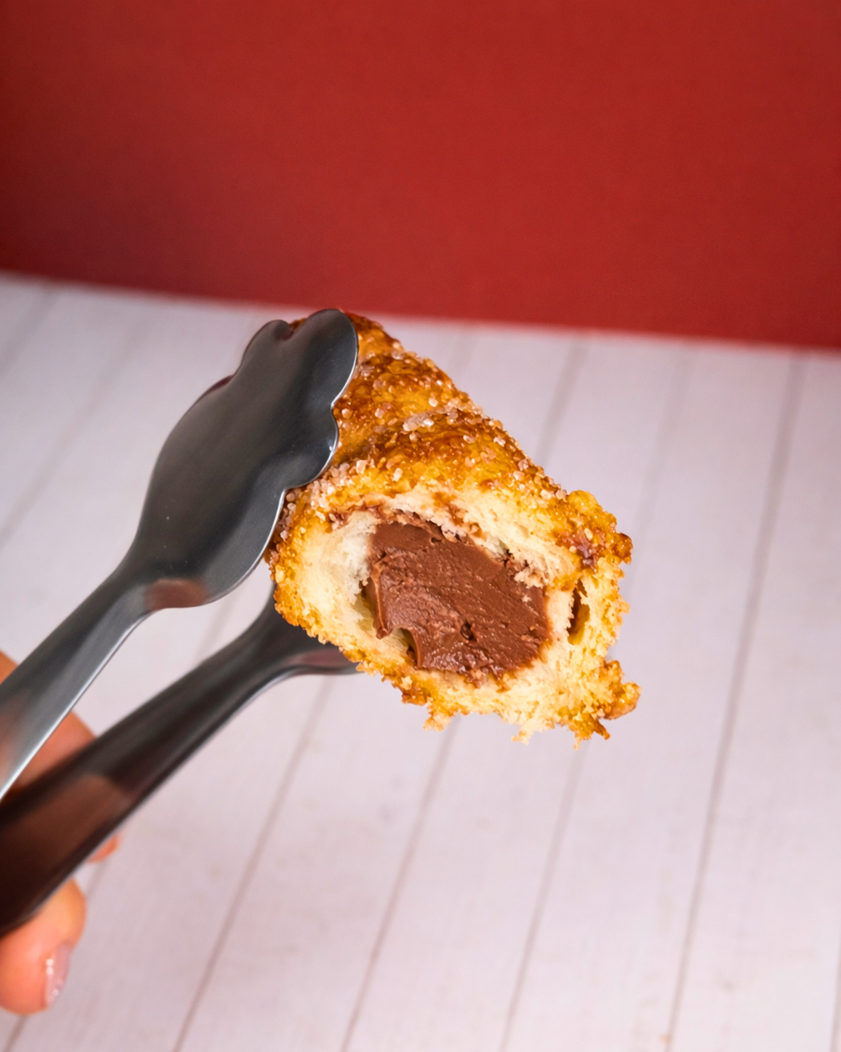 Medri Cannolino Sfoglia Chocolate pastry with layered flaky dough and chocolate filling, topped with a chocolate drizzle.