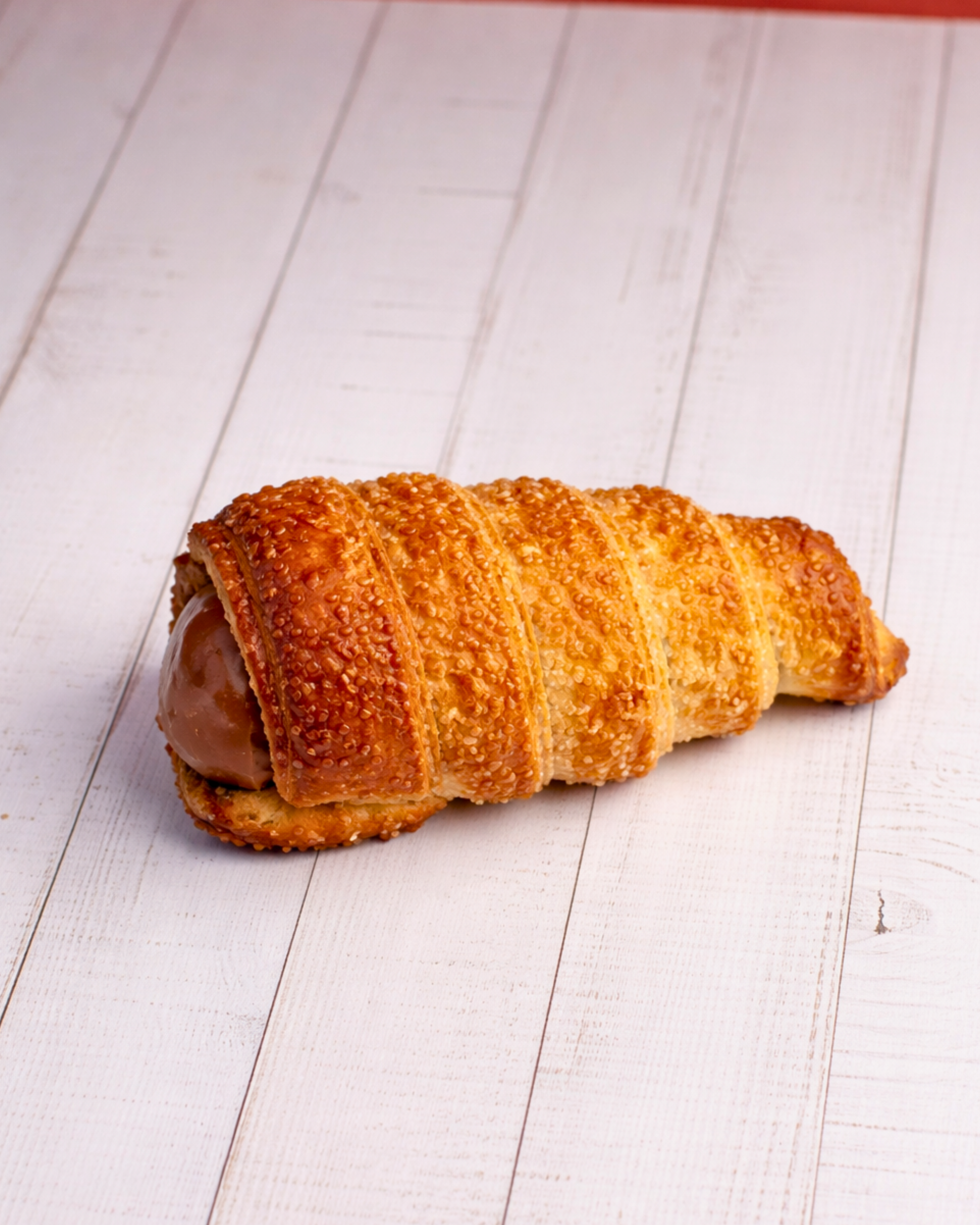 Medri Cannolino Sfoglia Chocolate, a delicate pastry with chocolate filling and flaky pastry layers, displayed on a white plate.