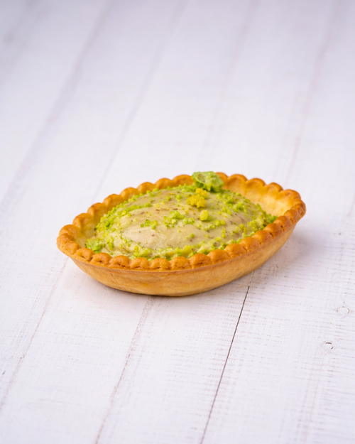 Medri Barchetta Pistacho chocolate confection with pistachio pieces in a boat-shaped shell, displayed on a white background.