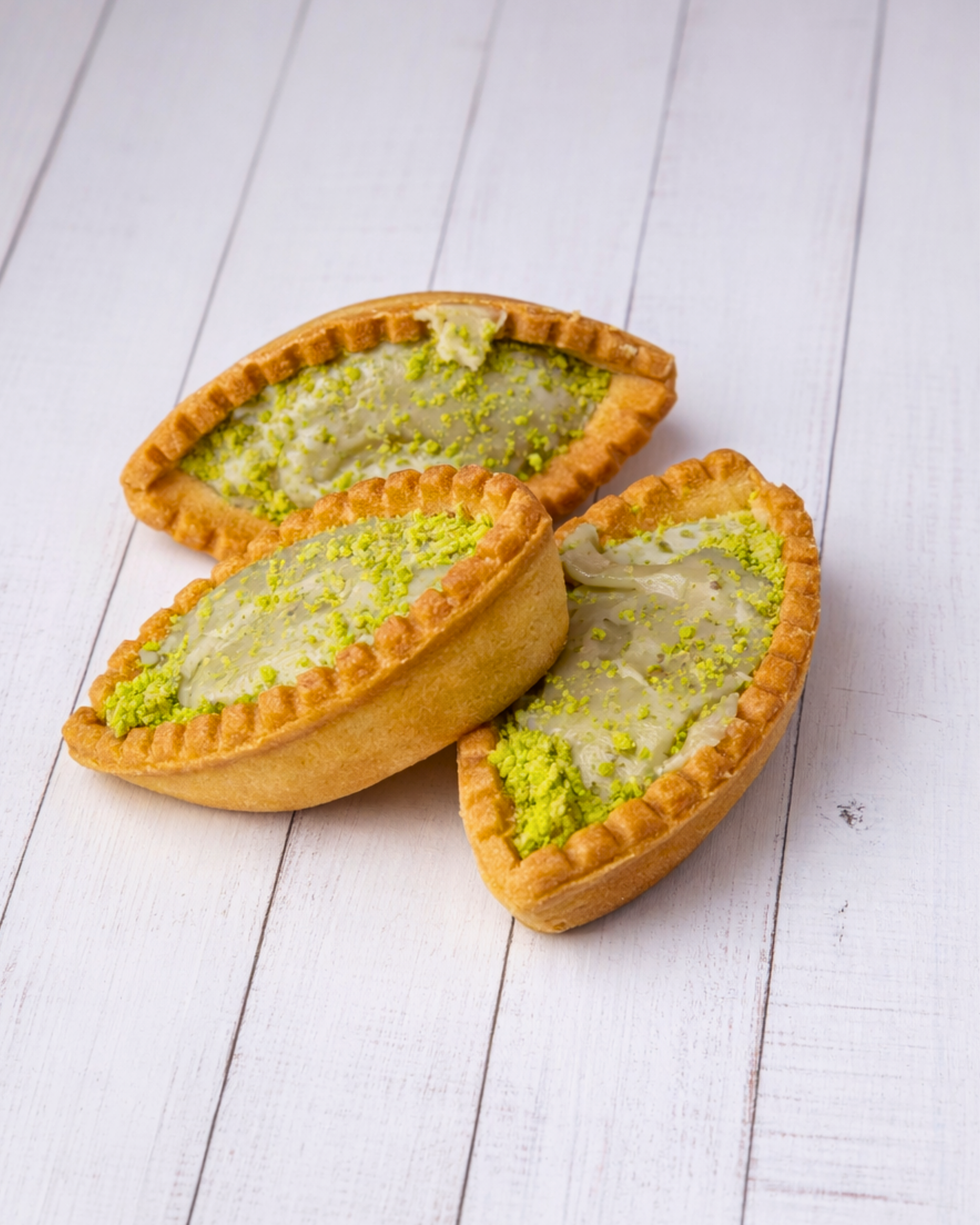 Medri Barchetta Pistacho ice cream cone with pistachio-flavored scoop in a waffle cone, topped with chopped pistachios.