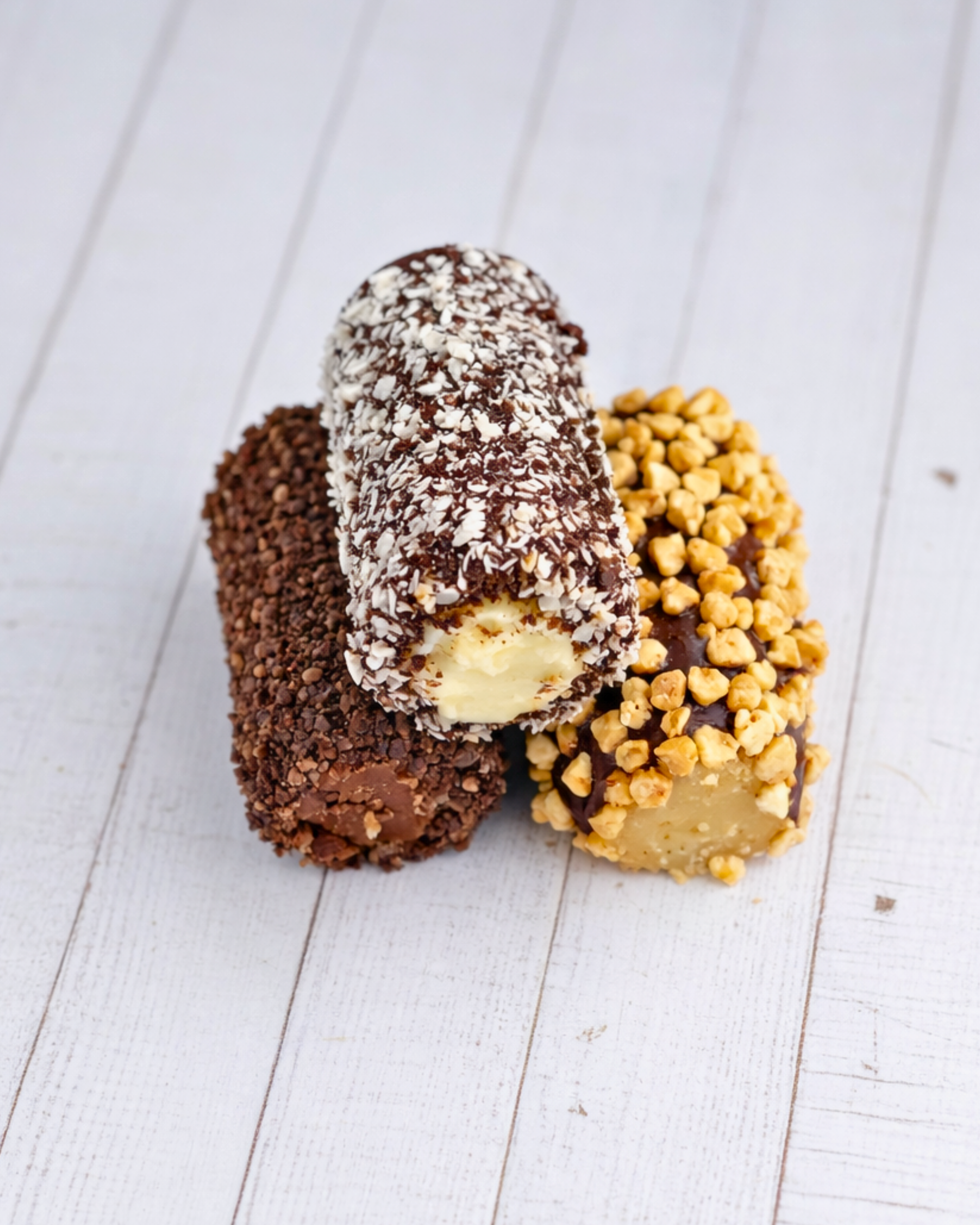 Assorted Medri Cannolli Twill box with colorful, crispy cannoli shells filled with sweet cream, displayed in an open box.
